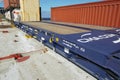 Empty blue flat rack container secured on deck of container vessel.