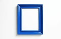Empty blue picture frame rests on clean white background. Classic rectangular border provides versatile space for adding custom Royalty Free Stock Photo