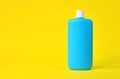 Empty blue plastic bottle on a yellow background Royalty Free Stock Photo