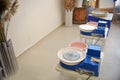 An empty blue potter`s wheel is prepared for the group practice of lepui pottery from clay. Tools for making clay products in a