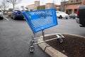 Empty blue shopping cart on the parking lot