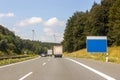 Empty blue sign board at the roadside on freeway in summer lands Royalty Free Stock Photo