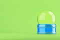 Empty blue snow globe on bright green background Royalty Free Stock Photo