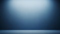 Empty Blue Studio Room With Textured Wall and Floor Lit by Soft Spotlights Creating a Gradient of Light and Shadow Royalty Free Stock Photo