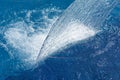 Empty blue water pool with a waterfall stream in action. Relaxation pool, spa hydrotherapy. The concept of hydromassage and Royalty Free Stock Photo