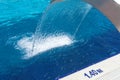 Empty blue water pool with a waterfall stream in action. Relaxation pool, spa hydrotherapy. The concept of hydromassage and Royalty Free Stock Photo