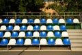 Empty blue and white plastic seats on stands of stadium in open. Royalty Free Stock Photo