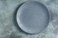 Empty bluish plate on concrete