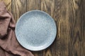 Empty bluish plate on oak wooden background