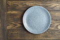 Empty bluish plate on wooden table