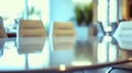 Empty boardroom table with chairs arranged around,against backdrop of floortoceiling windows Royalty Free Stock Photo