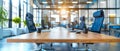 An empty boardroom table with chairs arranged around,against backdrop of floortoceiling windows Royalty Free Stock Photo