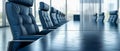 An empty boardroom table with chairs arranged around,against backdrop of floortoceiling windows Royalty Free Stock Photo