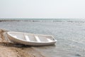 Empty boat on a deserted beach Royalty Free Stock Photo