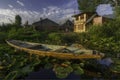 Empty boat and a local village house in Dal lake,Srinagar,Kashmir,India Royalty Free Stock Photo