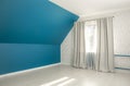 Empty bold blue tilted bed room wall gray curtains white sun day curtains.