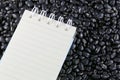 Empty book on the pile black beans. Royalty Free Stock Photo