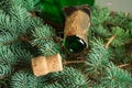 An empty bottle of champagne and a cork lying on spruce branches, focus on the neck of the bottle, Christmas background Royalty Free Stock Photo