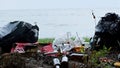 Empty bottles and containers polluting seashore, tons of garbage damaging nature