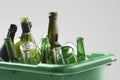 Empty bottles in green container close-up