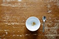 Empty bowl with little cereal on dark wooden table Royalty Free Stock Photo