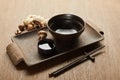 empty bowl near chopsticks, soy sauce, ginger root on wooden tray Royalty Free Stock Photo