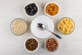 Empty bowl, spoon and different ingredients for preparation muesli Royalty Free Stock Photo