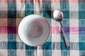 Empty bowl and spoon on tablecloth, top view. Royalty Free Stock Photo