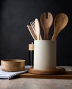 Empty bowl and wooden spoons on a table, black background Royalty Free Stock Photo