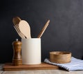 Empty bowl and wooden spoons on a table, black background Royalty Free Stock Photo