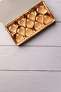 Empty box of chocolate candies on white wooden table, top view. Space for text Royalty Free Stock Photo