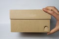 Empty box from shoes in male hands on a white isolated background. Front view. Royalty Free Stock Photo