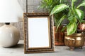 Empty brass picture frame on wooden background. Royalty Free Stock Photo