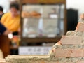 Empty bricks wall with blurred cafe background.