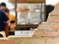 Empty bricks wall with blurred cafe background. Royalty Free Stock Photo