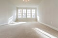 Spacious empty room with natural light from windows in a modern house Royalty Free Stock Photo