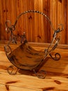 Antique empty firewood basket by a wooden wall