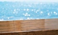 Empty brown glossy wood table top with blur sky and sea boekh background,banner mock up template for display of product Royalty Free Stock Photo