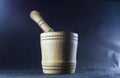 Empty brown mortar with a pestle wooden. A drinking bowl for crushing of spices. Black background. Kitchen utensils. Ware.