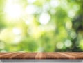 Empty brown wood table top with sun and blur green tree bokeh ba Royalty Free Stock Photo