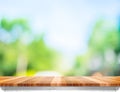 Empty brown wood table top with sun and blur green tree bokeh ba Royalty Free Stock Photo