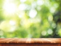 Empty brown wood table top with sun and blur green tree bokeh ba Royalty Free Stock Photo