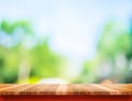 Empty brown wood table top with sun and blur green tree bokeh ba Royalty Free Stock Photo