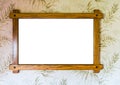 Empty brown wooden picture frame hanging on a wall with decorated wallpaper background Royalty Free Stock Photo