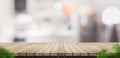 Empty brown wooden plank table top with blurred home kitchen wit