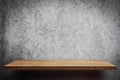 Empty brown wooden shelf on gray wall Royalty Free Stock Photo