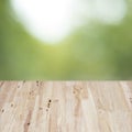 Empty brown wooden table in front of abstract blurred bokeh background of green nature outoor. Royalty Free Stock Photo