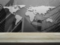 Empty brown wooden table top over black and white world map with Royalty Free Stock Photo