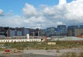 empty brownfield site in leeds england with weeds growing through concrete and a burned out abandoned car surrounded by Royalty Free Stock Photo