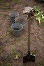 Empty buckets with pail and working glowes on soil background at